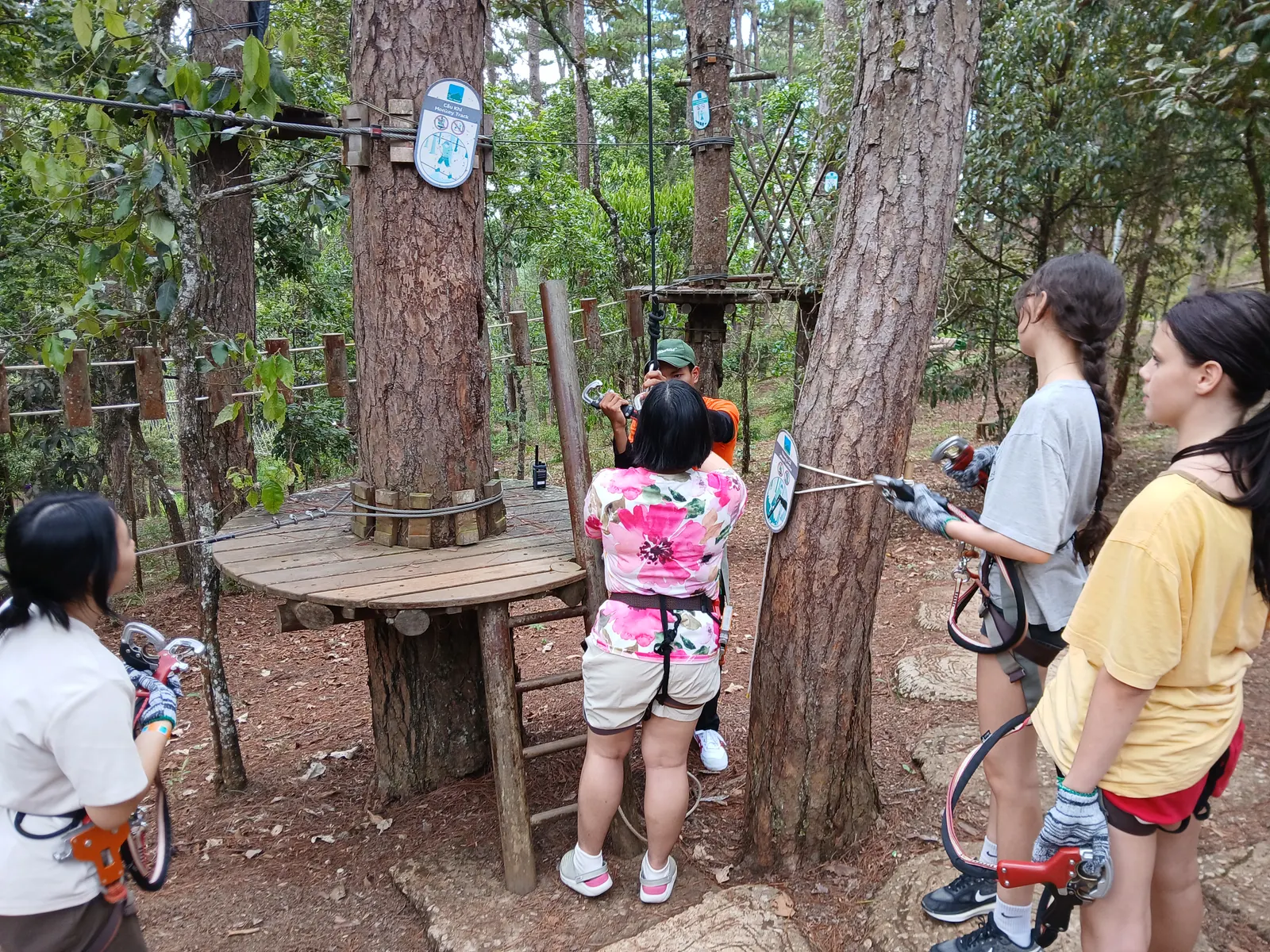 Getting harnessed up for the high ropes course in the pines above Đà Lạt