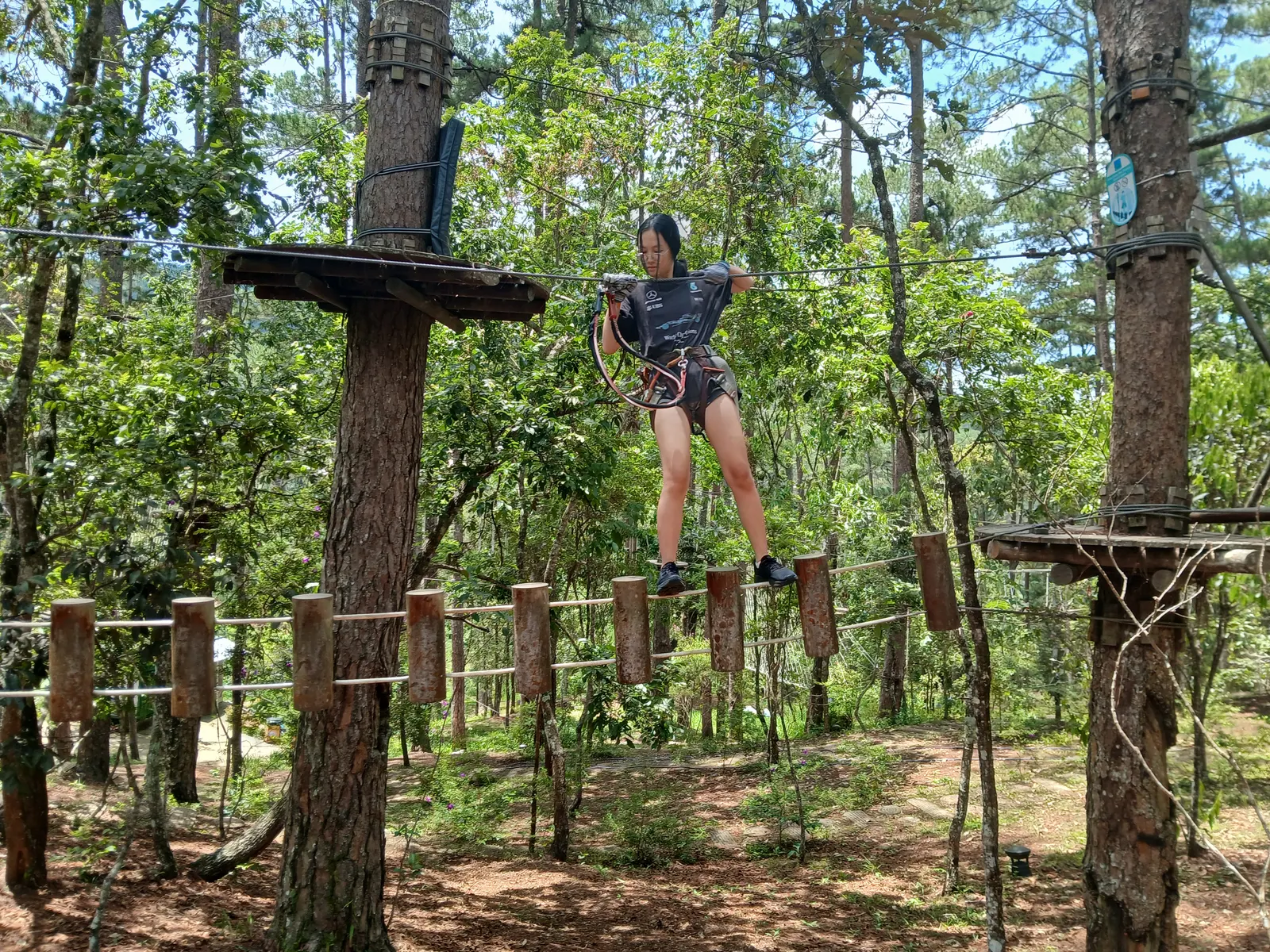 A student crossing the high ropes course on the Đà Lạt trip