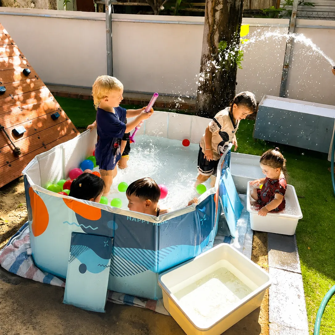 Children cooling off in the courtyard paddling pool