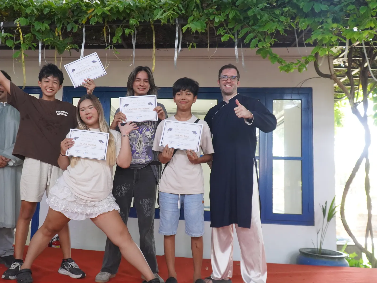 Graduating students celebrating with their certificates