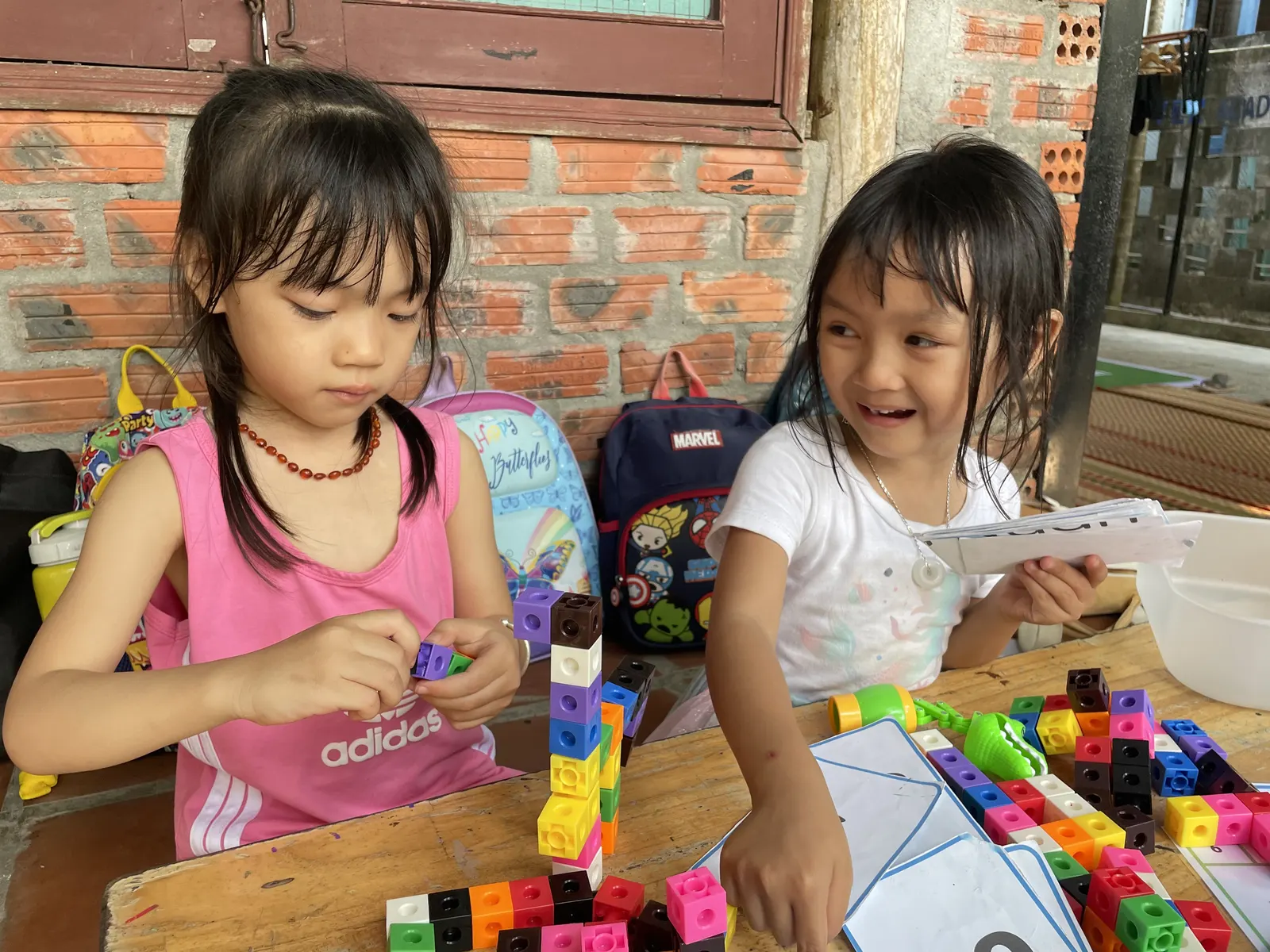 Students building towers from connecting cubes at March Mathness