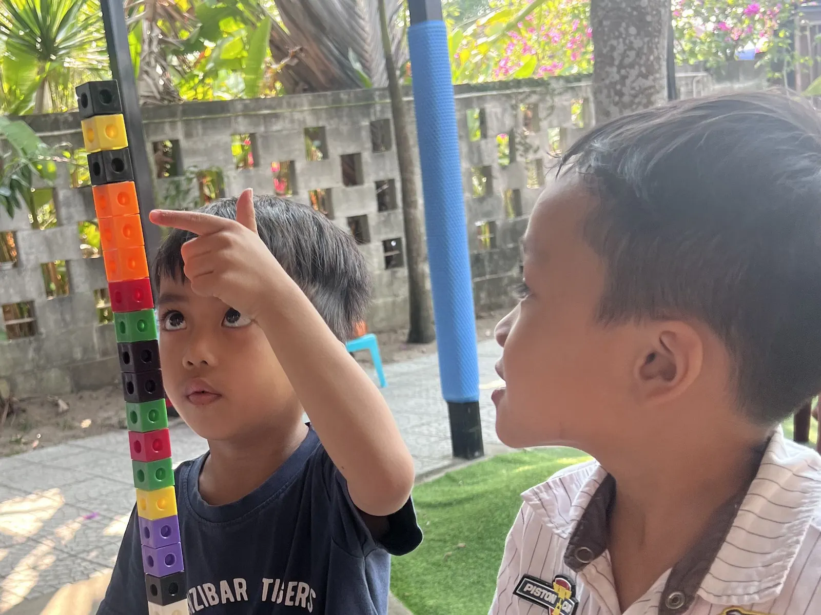 Two students with the cube tower they built at March Mathness
