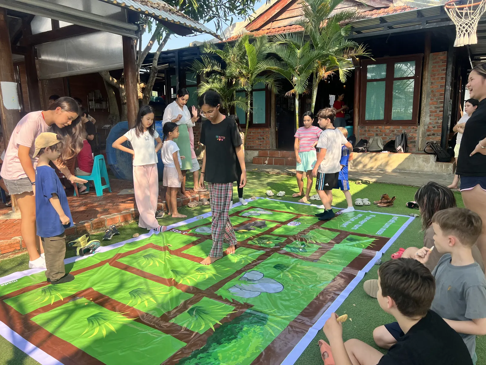 Children and parents solving the giant lawn maze at March Mathness