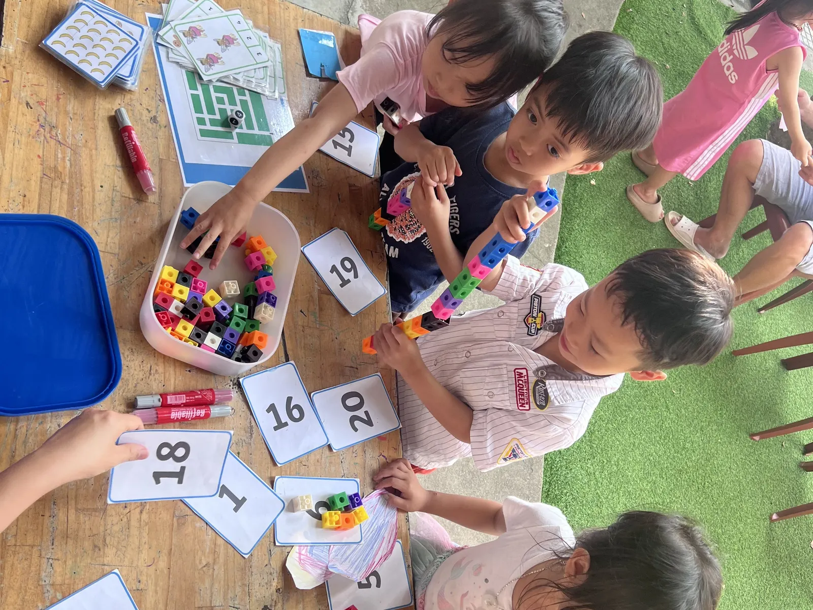 Early Years children matching cubes to number cards at March Mathness