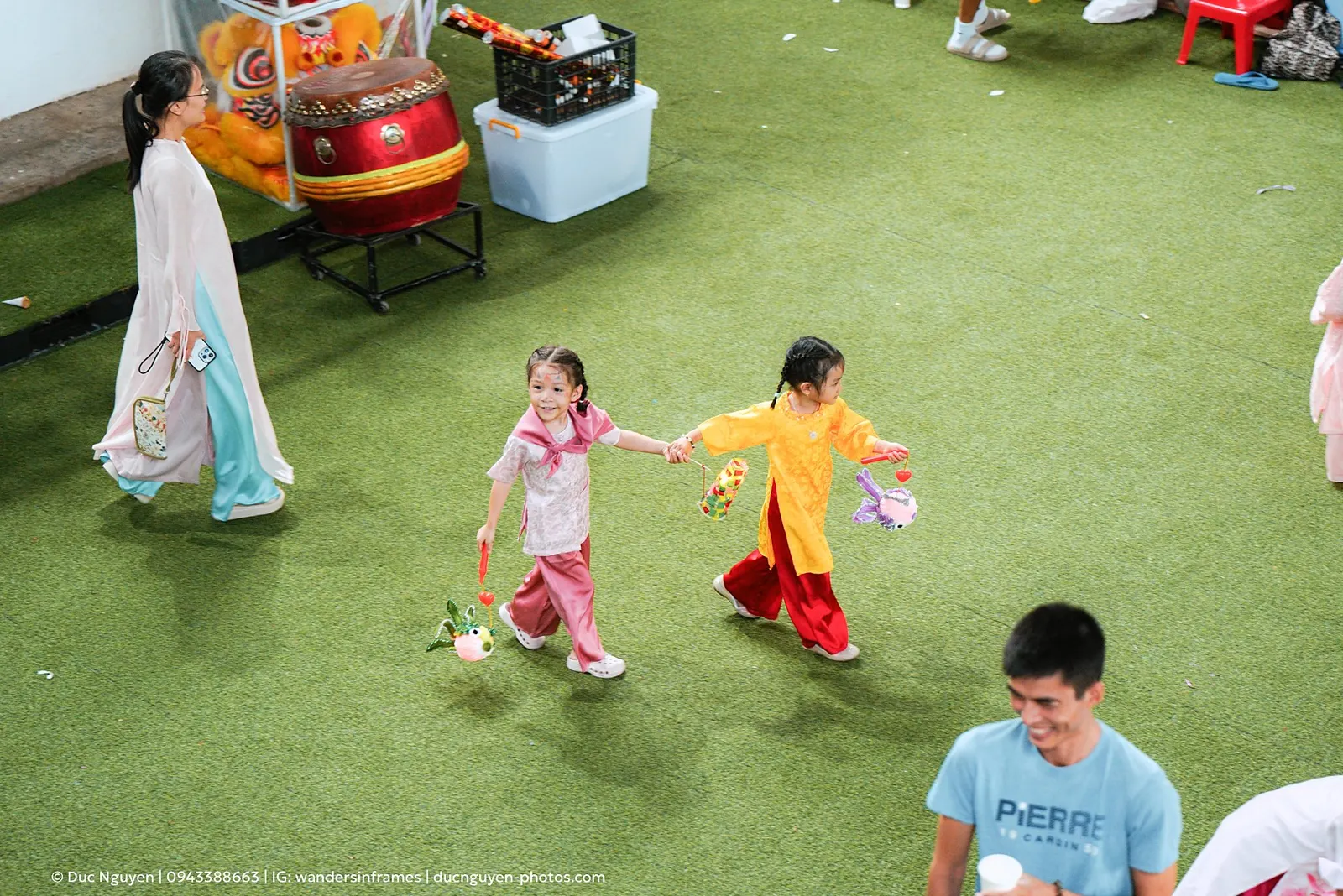 Two children walking hand in hand with lanterns at the Mid-Autumn Festival