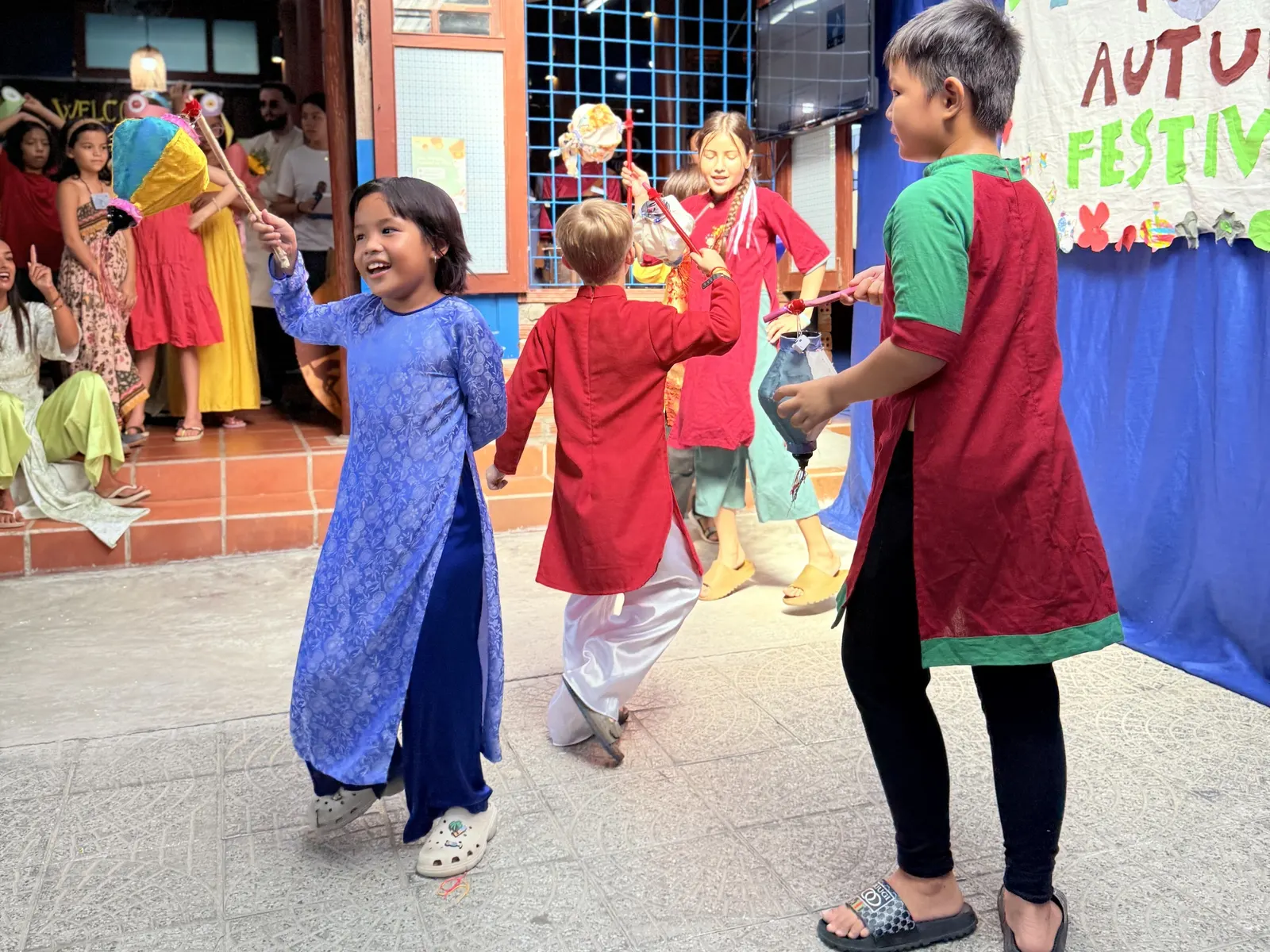 Students dancing in áo dài at the Mid-Autumn Festival