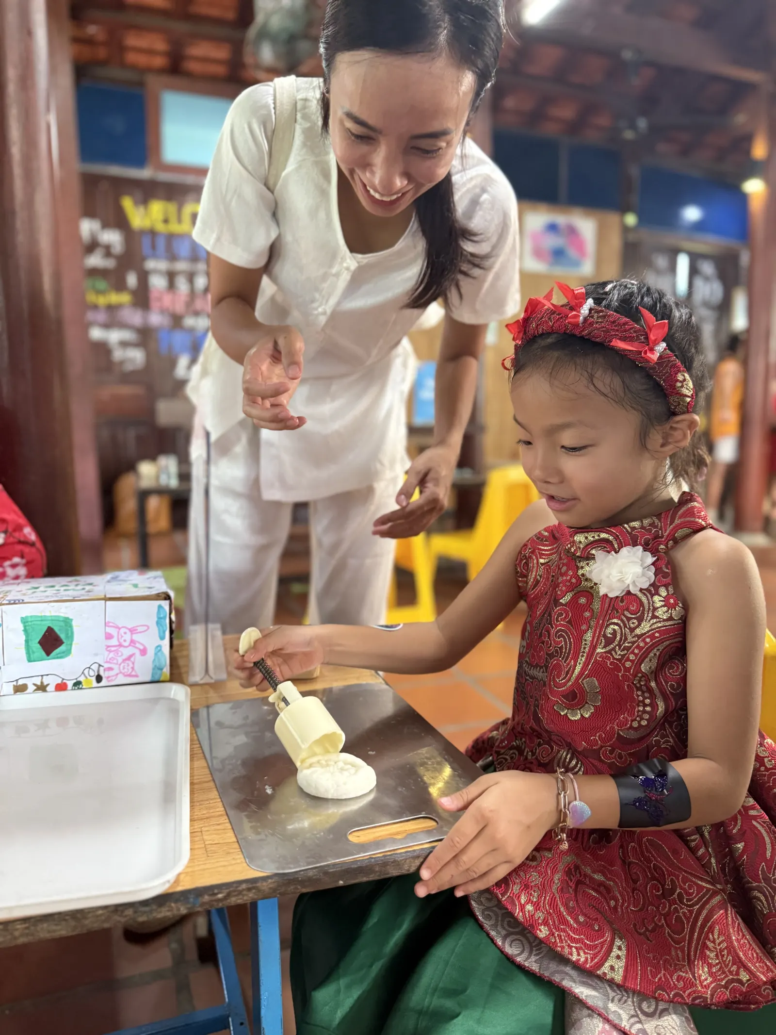 A child shapes a mooncake at a Mid-Autumn Festival stall