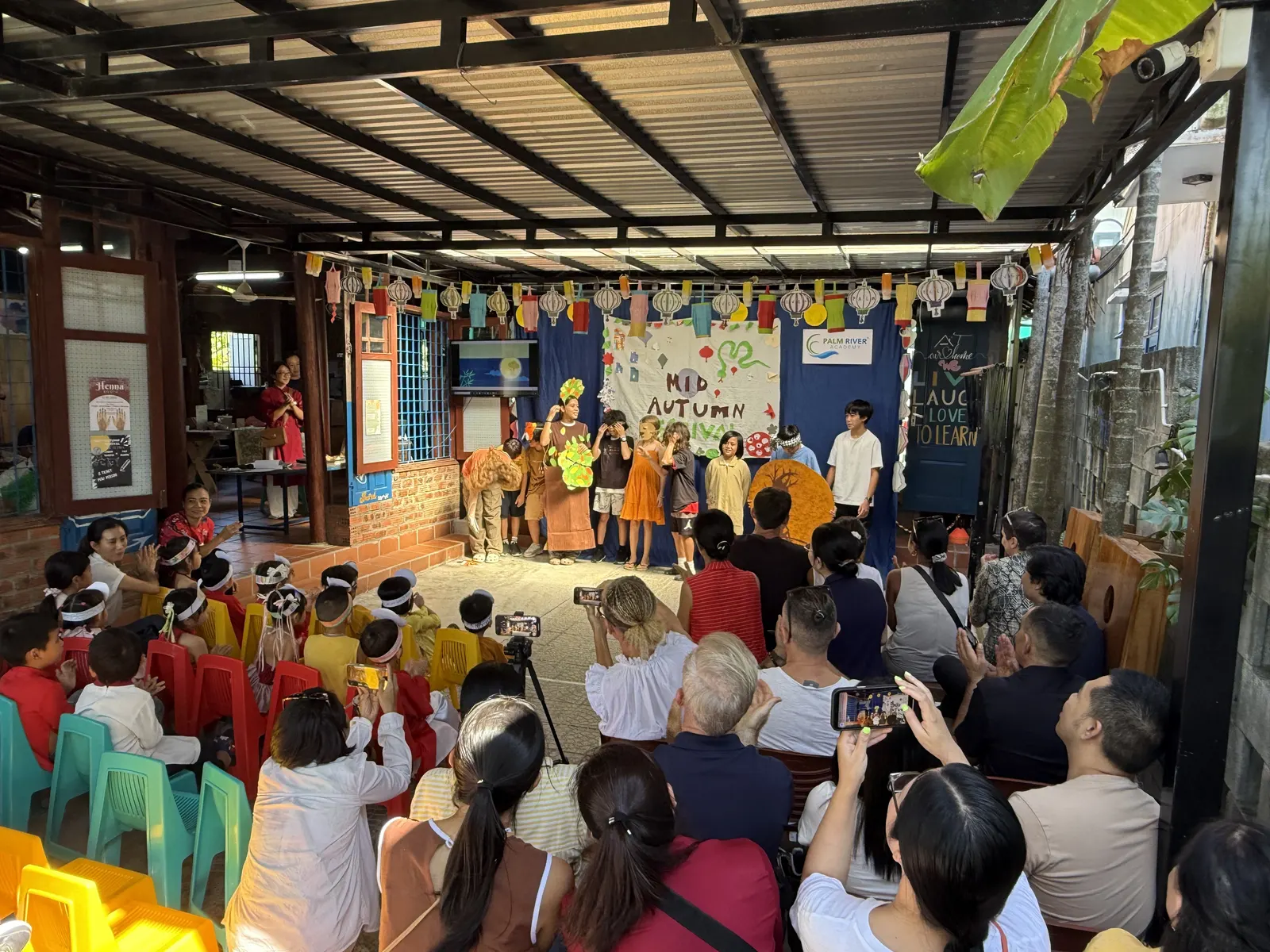 Families watching the Mid-Autumn Festival show under paper lanterns