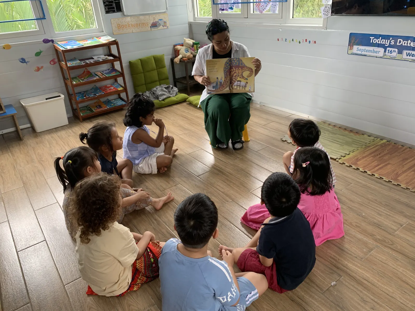Ms. Solo reading a big book to her Primary class