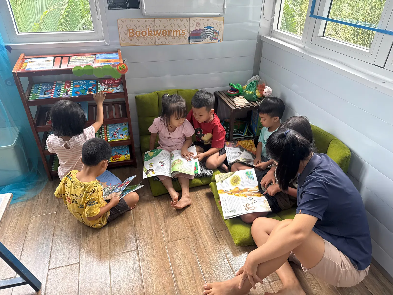 Ms. Duyen reading with Primary students in the book corner