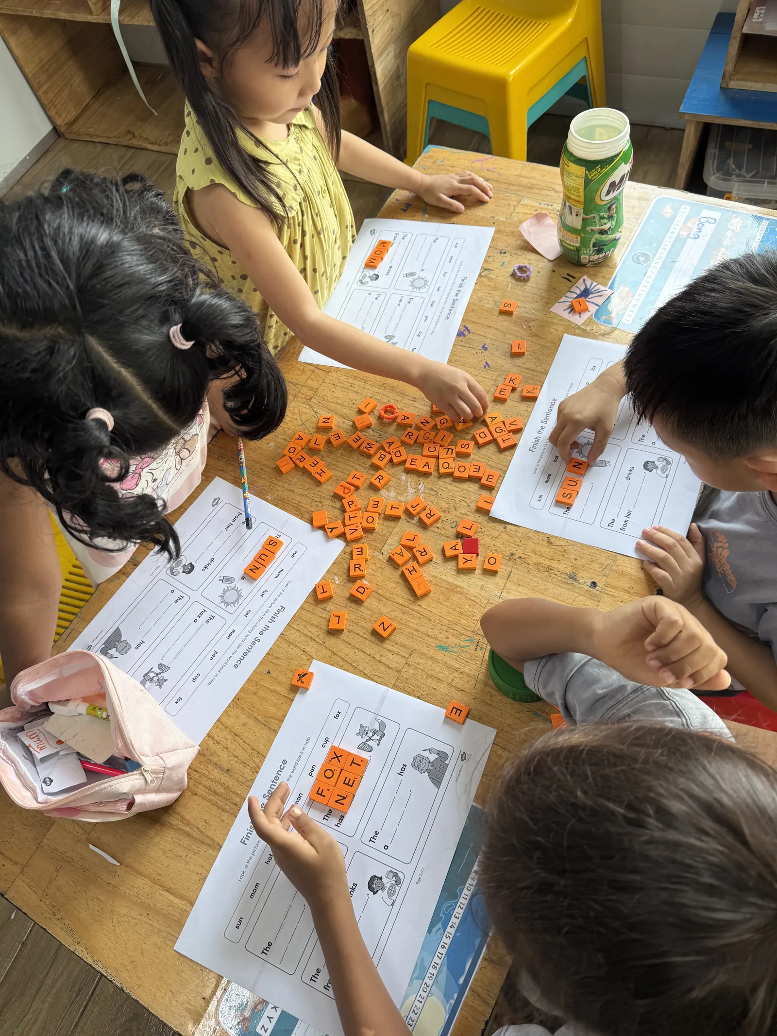 A Primary English lesson, working through worksheets with counters