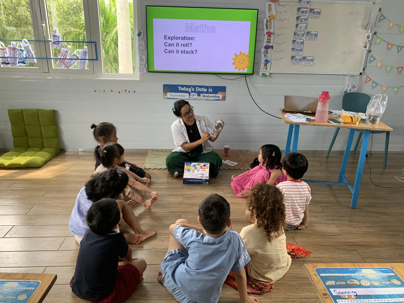 Ms. Solo setting up a maths exploration: can it roll, can it stack?