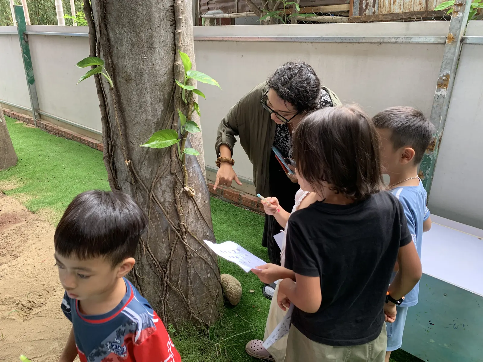 Primary students recording what they find in the garden at PRA