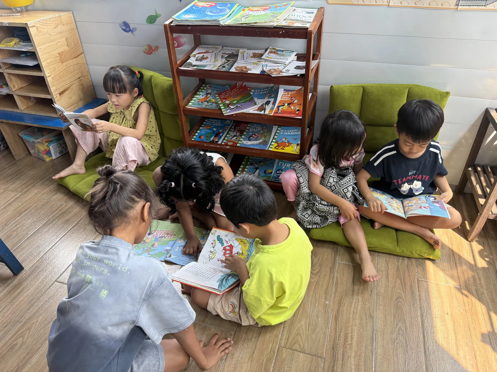 Primary students reading in the classroom book corner
