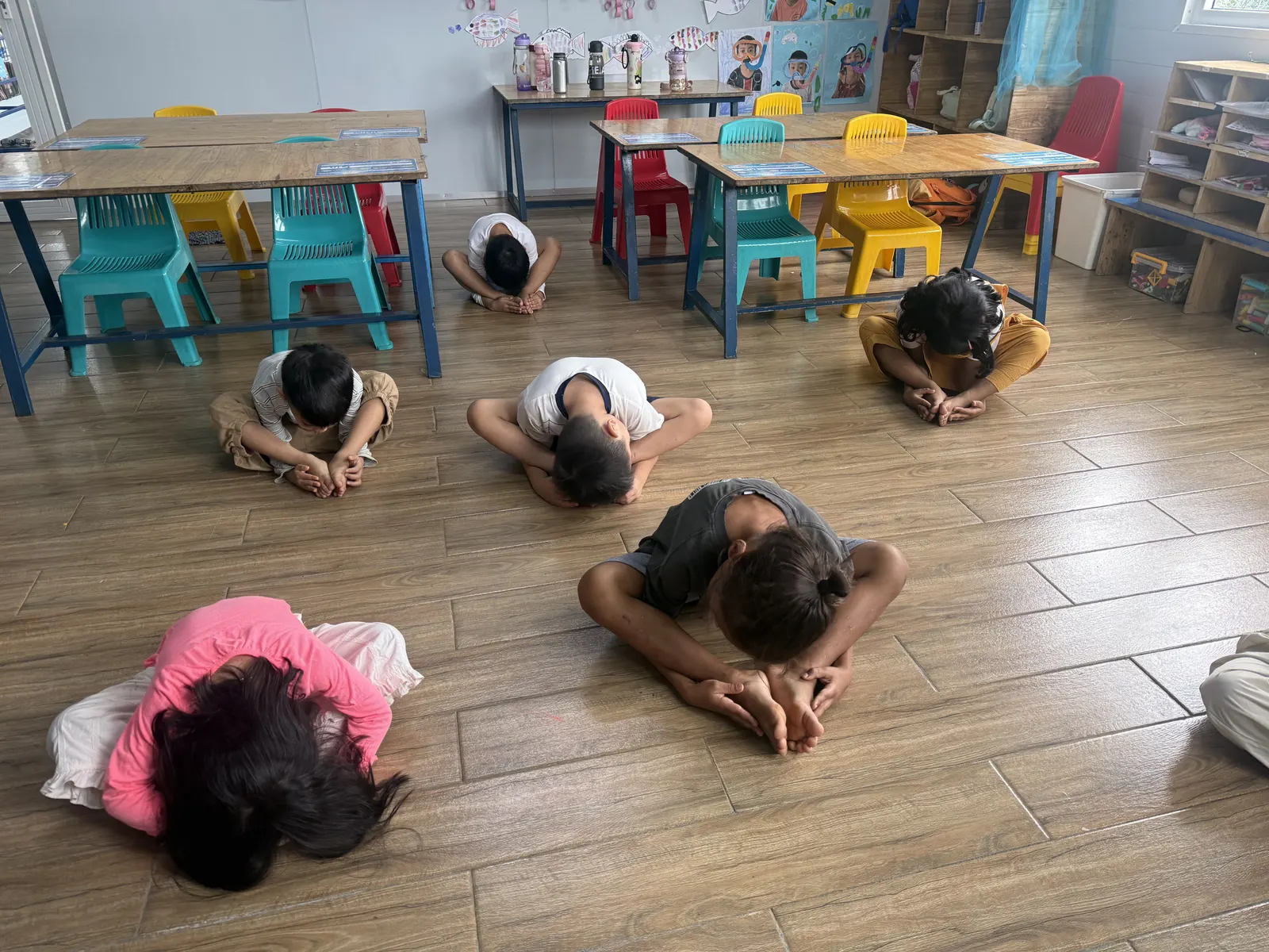 Primary students stretching together before a lesson