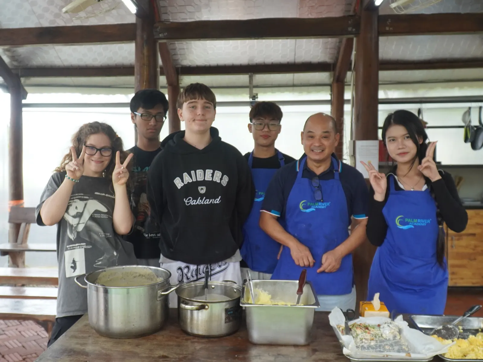 Upper Secondary students and their teacher with the Thanksgiving meal they cooked