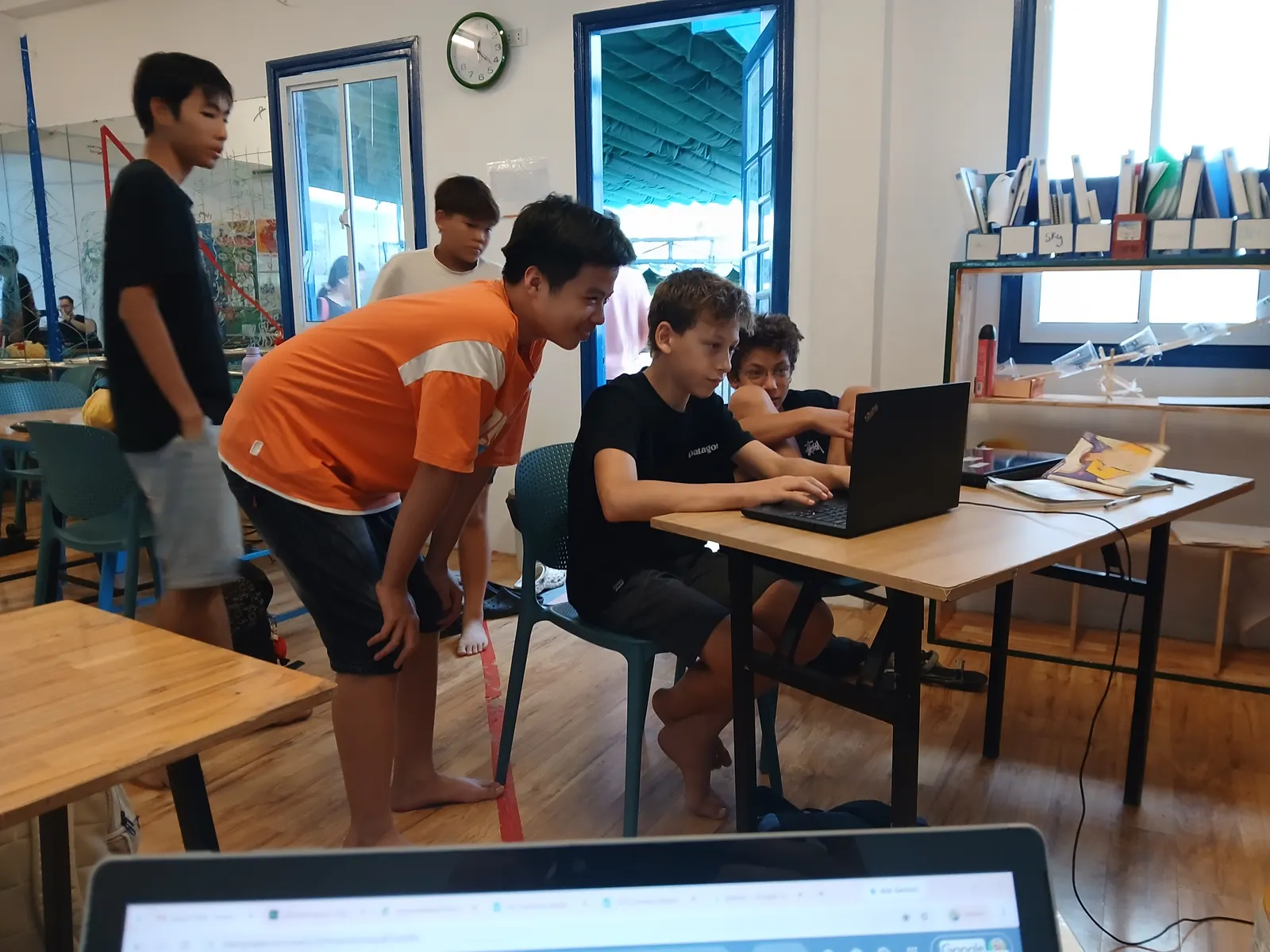 Upper Secondary students working on their own courses side by side, with a teacher on hand