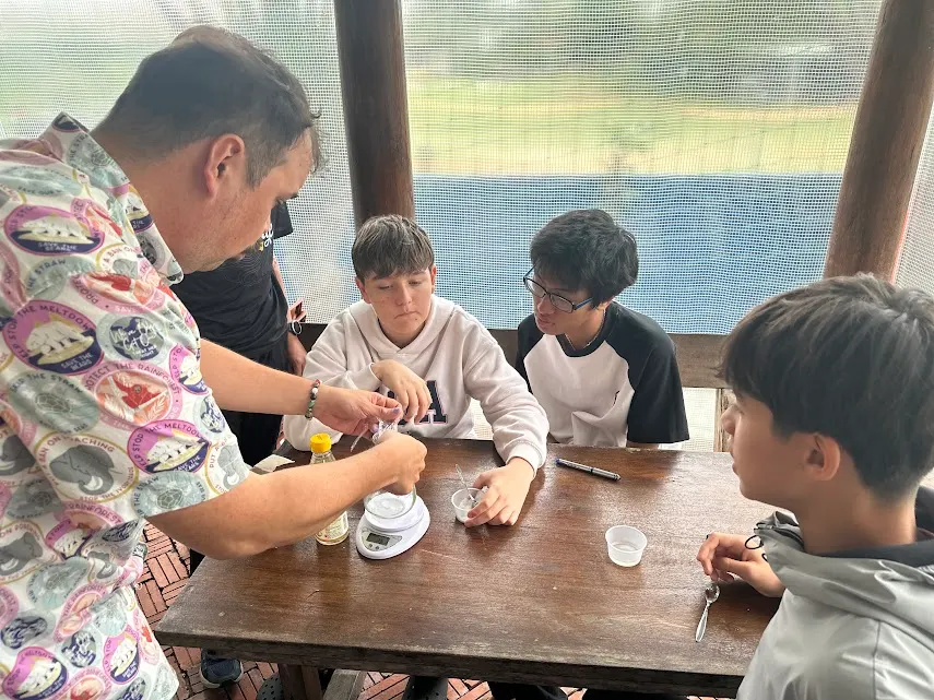 Mr. Seth running a hands-on science experiment with Upper Secondary students